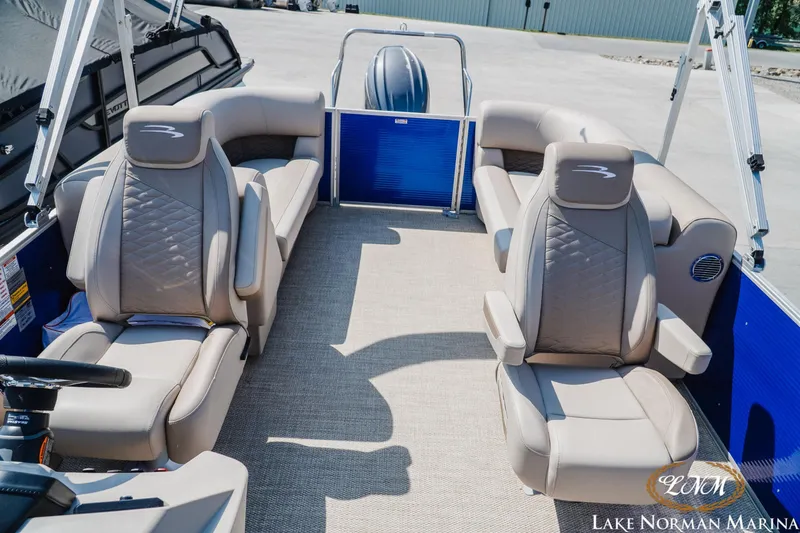 Slide: The Image of 2024 Bennington 22SSR-SPS pontoon boat interior with beige seating and blue accents. - 18