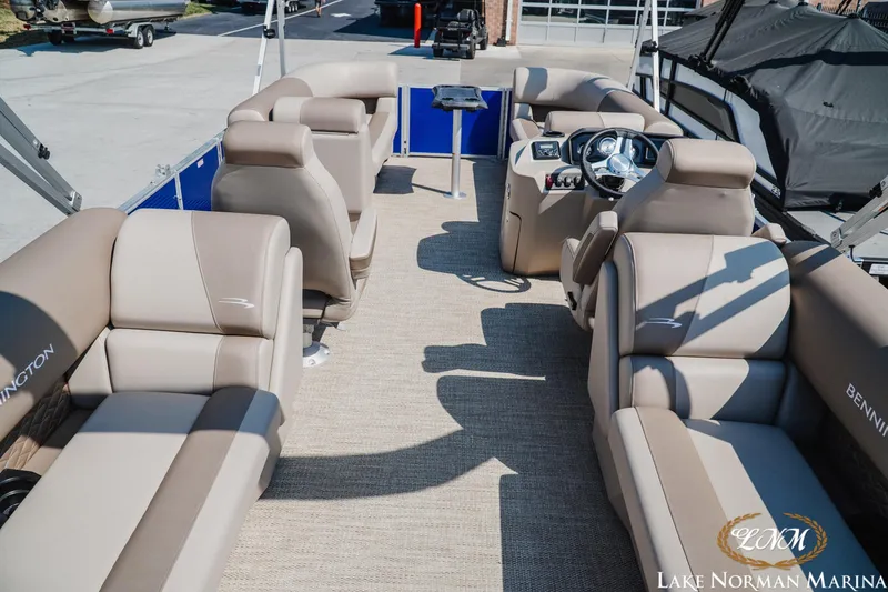 Slide: The Image of 2024 Bennington 22SSR-SPS pontoon boat interior with beige seating at Lake Norman Marina. - 5