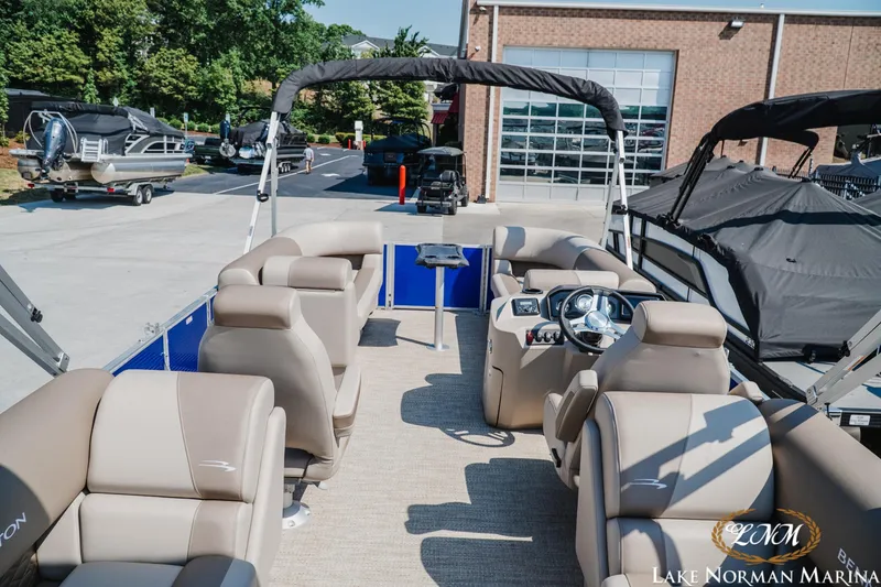 Slide: The Image of 2024 Bennington 22SSR-SPS pontoon boat with beige seating at Lake Norman Marina. - 6