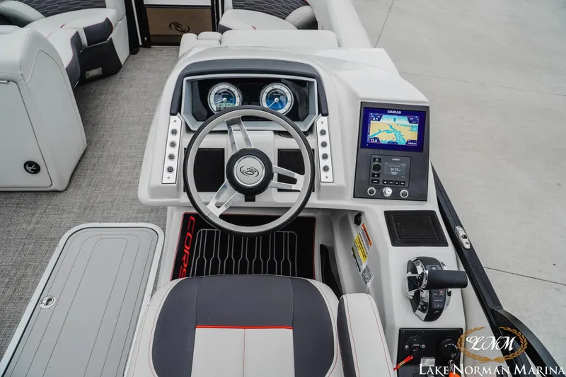 Slide: The Image of 2023 Barletta X23U boat dashboard with steering wheel and navigation display. - 11
