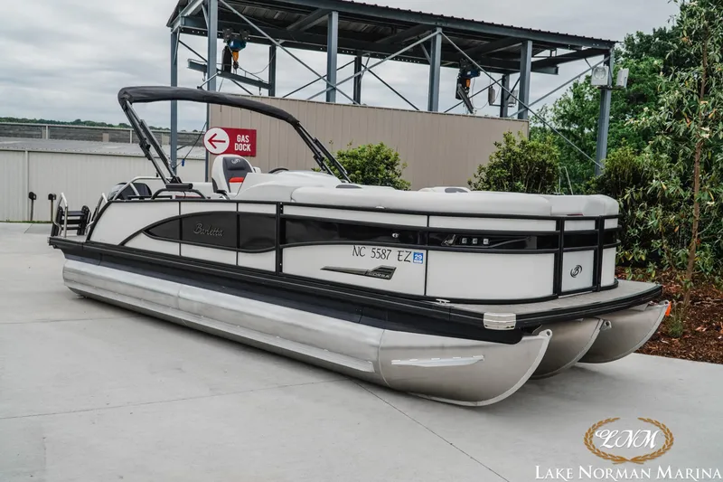 Slide: The Image of 2023 Barletta X23U pontoon boat at Lake Norman Marina, parked near gas dock. - 3