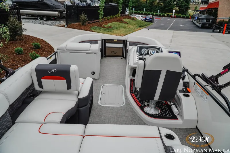Slide: The Image of 2023 Barletta X23U pontoon boat interior with plush seating and modern helm at Lake Norman Marina. - 7