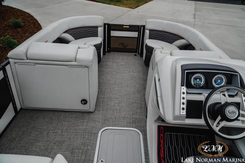 Slide: The Image of 2023 Barletta X23U boat interior with plush seating and modern dashboard at Lake Norman Marina. - 9