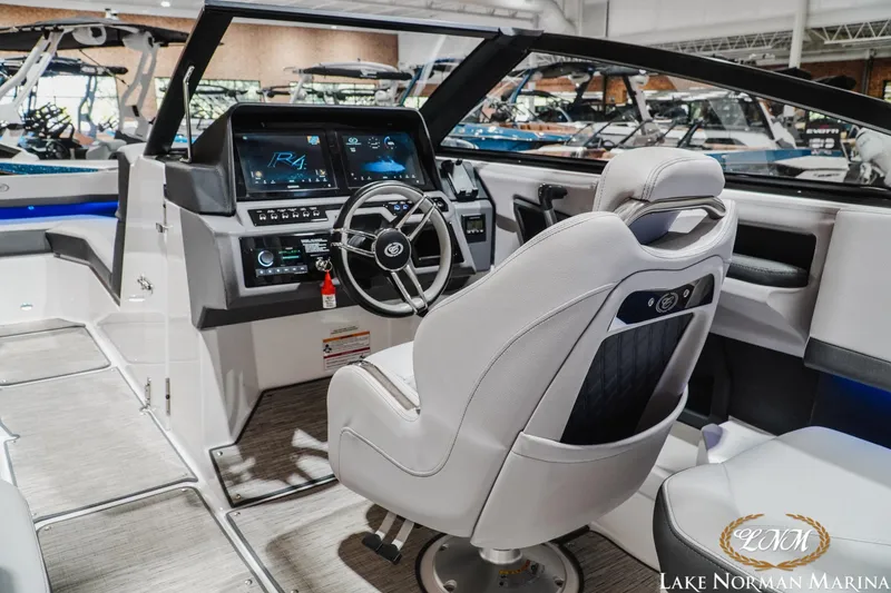 Slide: The Image of Interior of 2025 Cobalt R4 boat with modern dashboard and steering wheel at Lake Norman Marina. - 12