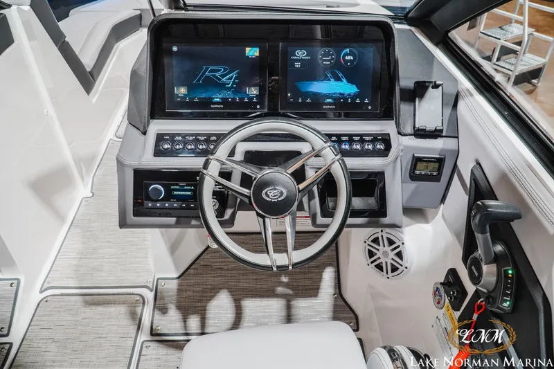 Slide: The Image of 2025 Cobalt R4 boat dashboard with modern controls and digital displays at Lake Norman Marina. - 13