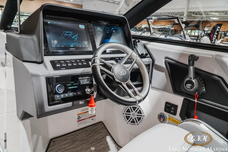 Slide: The Image of 2025 Cobalt R4 boat dashboard with steering wheel and advanced control panel. - 14