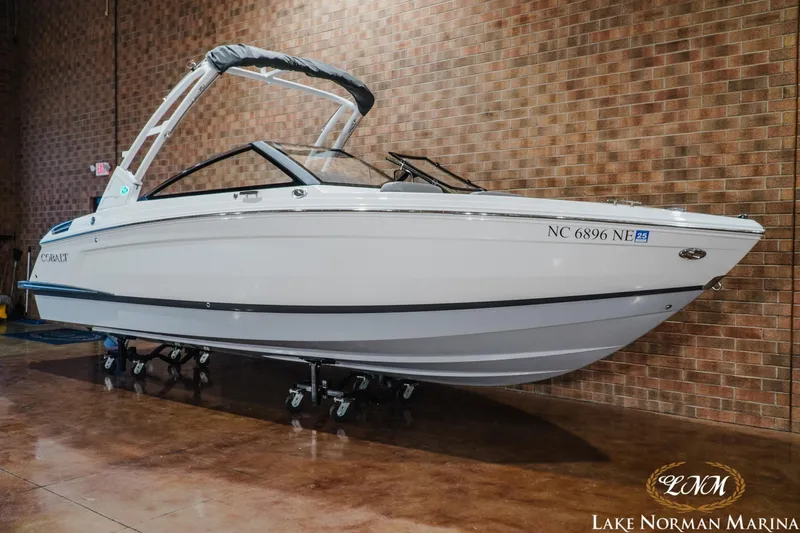 Slide: The Image of 2025 Cobalt R4 boat displayed indoors at Lake Norman Marina. - 2