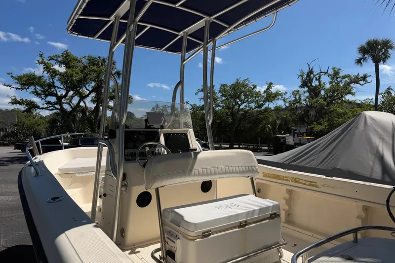 Slide: The Image of 2004 Key West 186 Sportsman boat with T-top and seating, parked outdoors. - 10