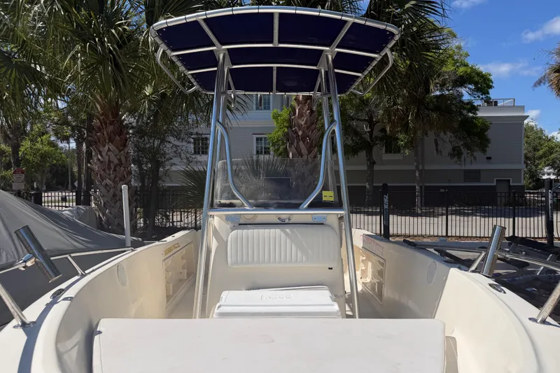 Slide: The Image of 2004 Key West 186 Sportsman boat with T-top, parked near palm trees. - 11