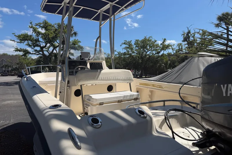Slide: The Image of 2004 Key West 186 Sportsman boat with Yamaha engine, parked outdoors under blue sky. - 13