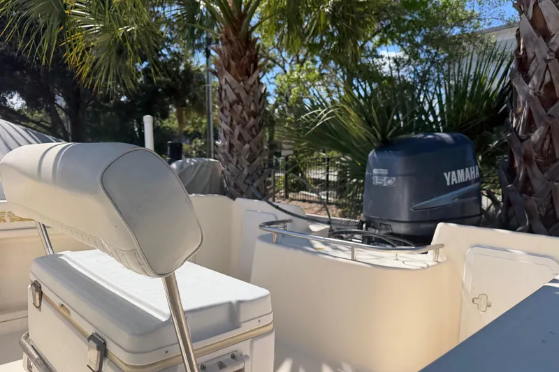 Slide: The Image of 2004 Key West 186 Sportsman boat with Yamaha engine, surrounded by palm trees. - 15