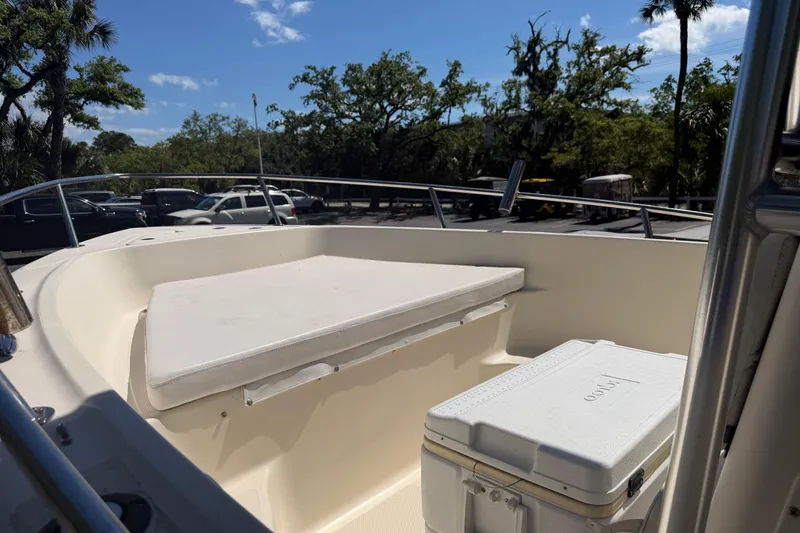Slide: The Image of 2004 Key West 186 Sportsman boat with seating and cooler, parked outdoors. - 4