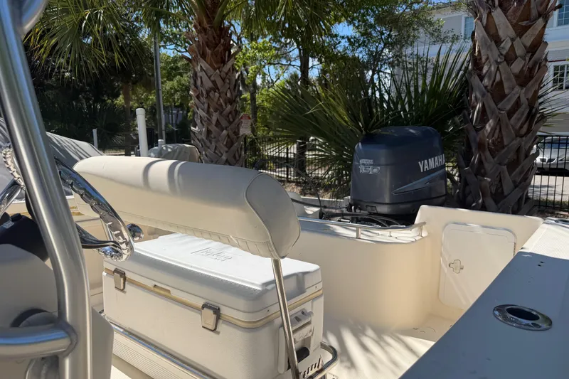 Slide: The Image of 2004 Key West 186 Sportsman boat with Yamaha engine, parked near palm trees. - 5