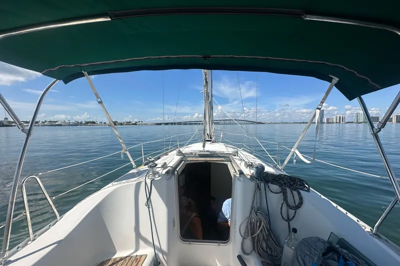 Slide: The Image of 2003 Beneteau Oceanis Clipper 331 sailboat on calm waters under a clear blue sky. - 18