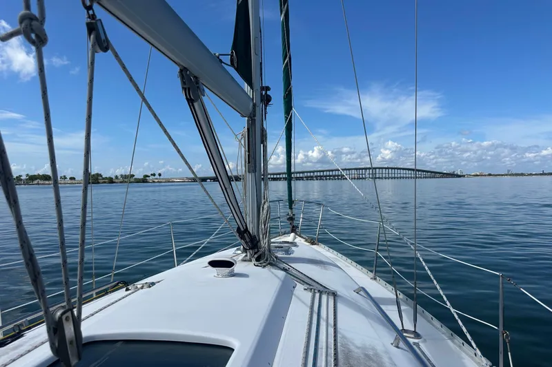 Slide: The Image of 2003 Beneteau Oceanis Clipper 331 sailing towards a distant bridge under clear blue skies. - 20