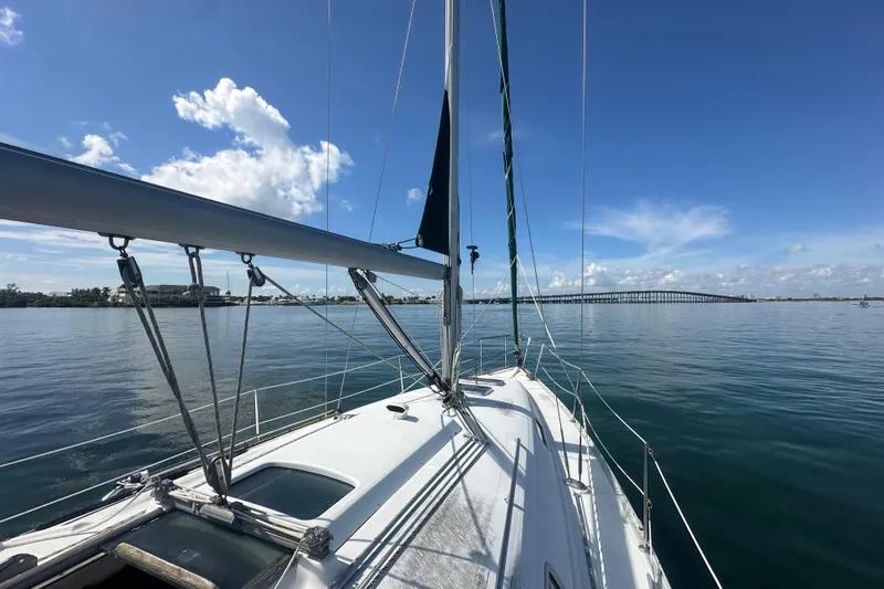 Slide: The Image of 2003 Beneteau Oceanis Clipper 331 sailing on calm waters under a clear blue sky. - 22