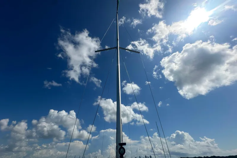 Slide: The Image of Mast of 2003 Beneteau Oceanis Clipper 331 against a bright blue sky with clouds. - 35