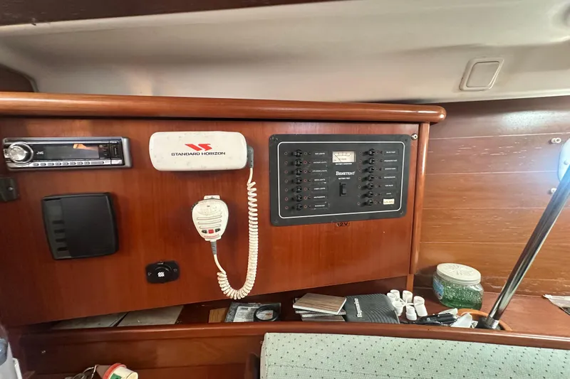 Slide: The Image of Interior control panel of 2003 Beneteau Oceanis Clipper 331 sailboat, featuring navigation and communication equipment. - 53