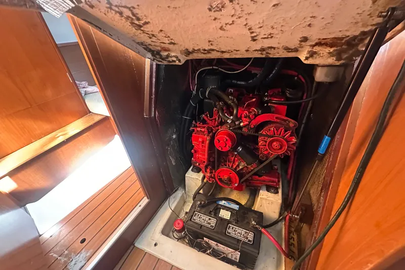 Slide: The Image of Engine compartment of 2003 Beneteau Oceanis Clipper 331 sailboat, featuring a red engine. - 73