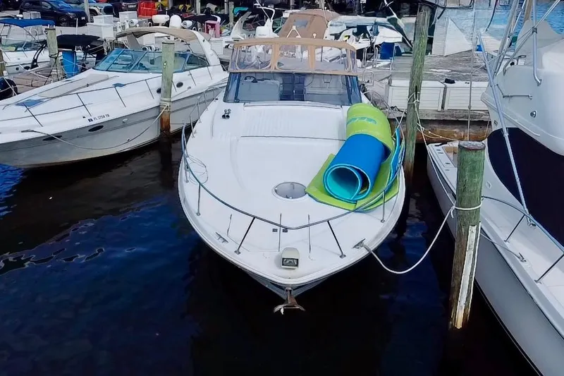 Slide: The Image of 2000 Trojan 440 Express yacht docked with rolled mats on deck. - 1