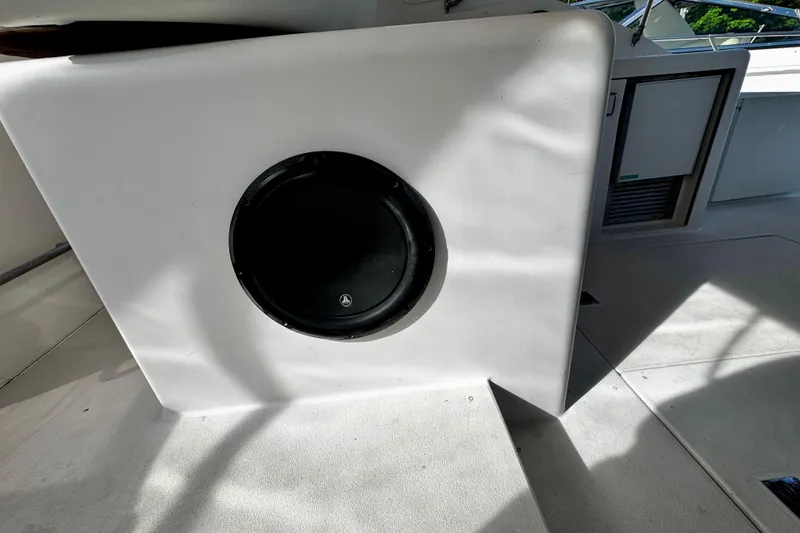 Slide: The Image of 2000 Trojan 440 Express boat interior with built-in speaker and storage compartment. - 14