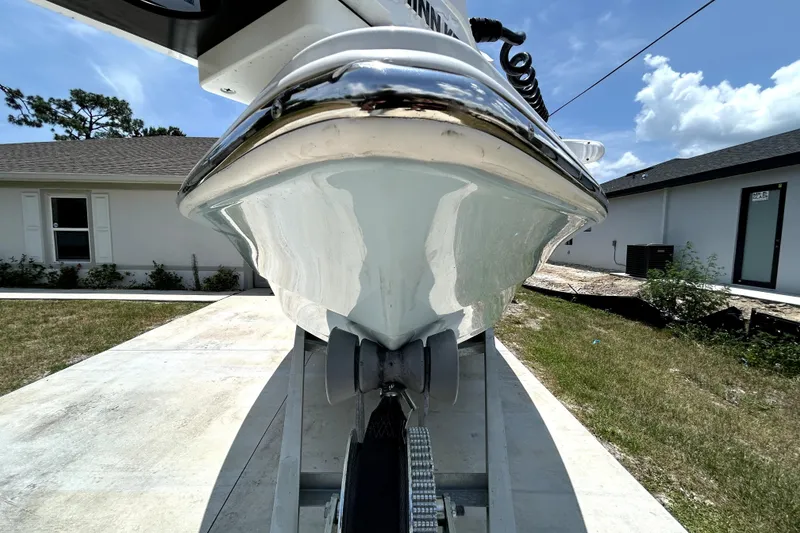 Slide: The Image of Front view of a 2025 Savannah 210X boat on a trailer, outdoors. - 11