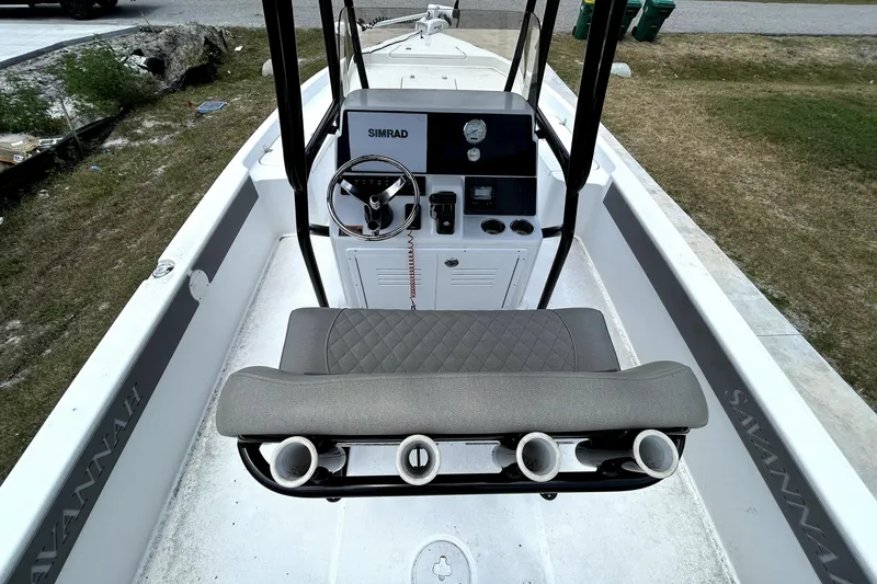 Slide: The Image of 2025 Savannah 210X boat interior with steering console and cushioned seating. - 15