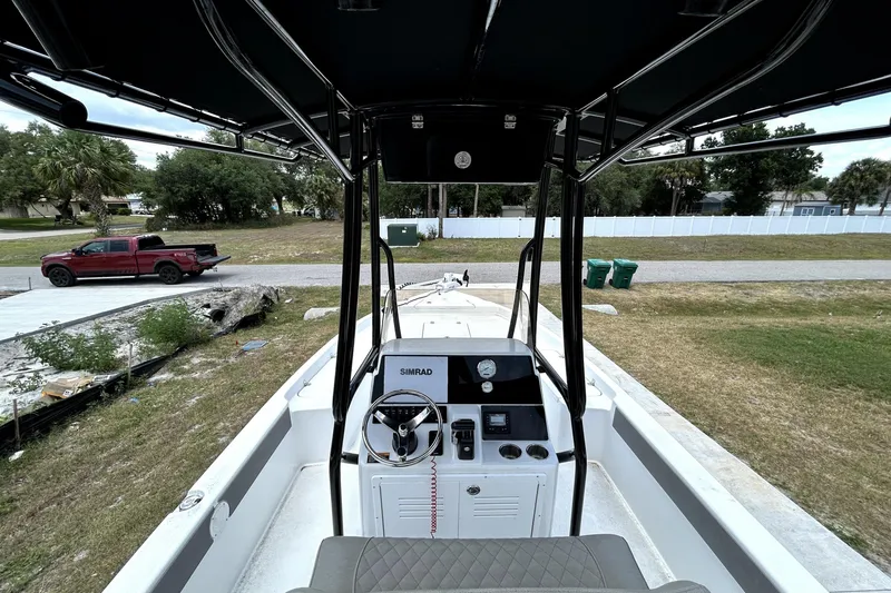 Slide: The Image of 2025 Savannah 210X boat interior with steering console and outdoor view. - 16