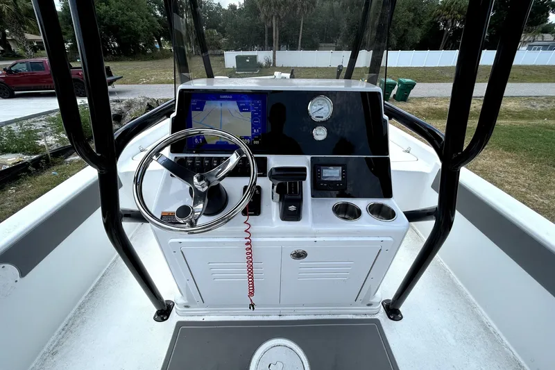 Slide: The Image of 2025 Savannah 210X boat console with steering wheel, navigation display, and gauges. - 17