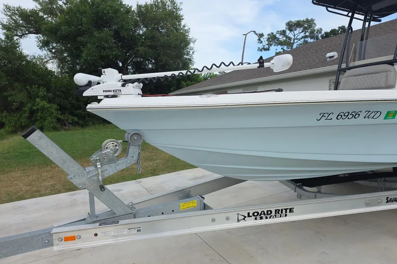 Slide: The Image of 2025 Savannah 210X boat on Load Rite trailer with Minn Kota trolling motor. - 2