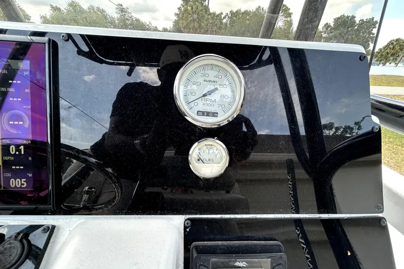 Slide: The Image of Dashboard of a 2025 Savannah 210X boat with RPM and fuel gauges. - 24