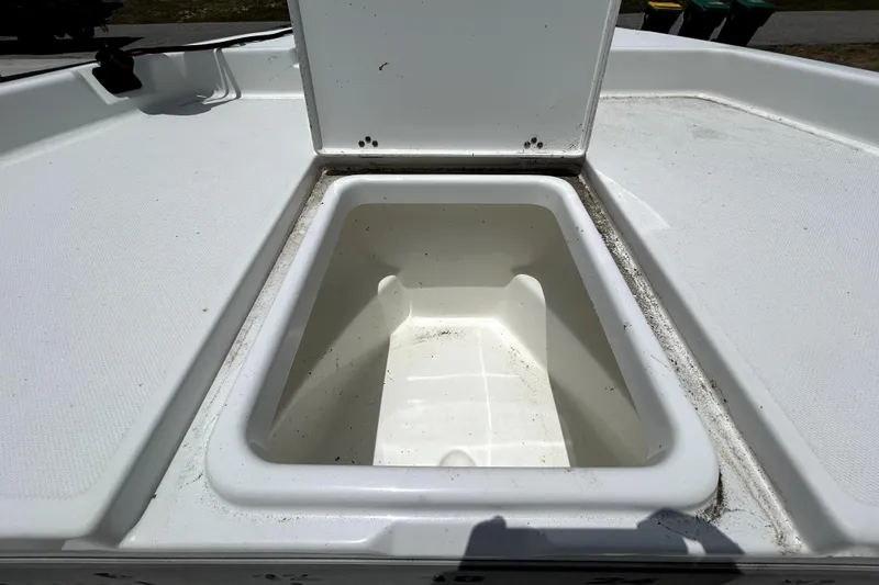 Slide: The Image of Open storage compartment on a 2025 Savannah 210X boat deck. - 34