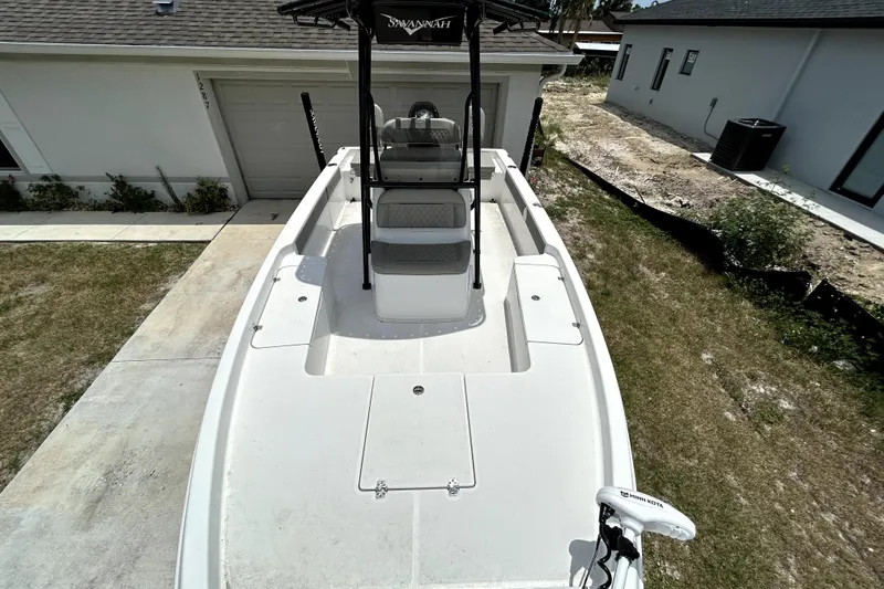Slide: The Image of 2025 Savannah 210X boat parked in driveway, showcasing sleek design and spacious deck. - 36