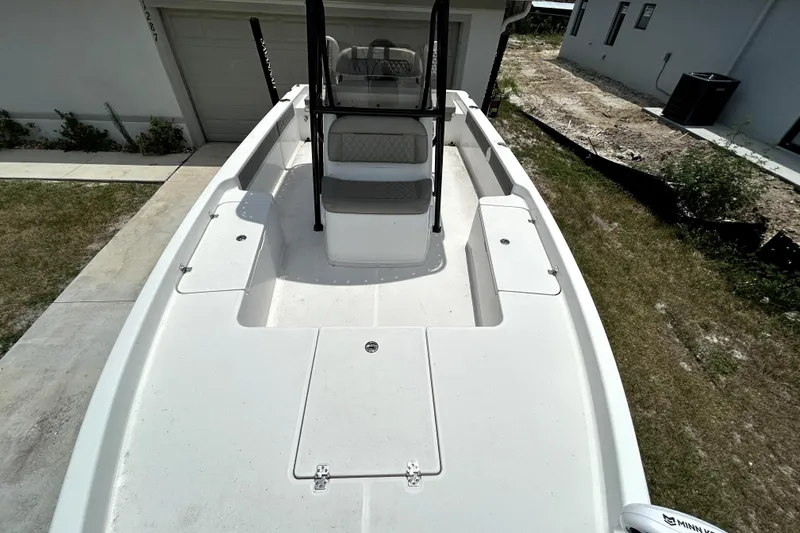 Slide: The Image of 2025 Savannah 210X boat, white deck, parked in driveway, modern design. - 37