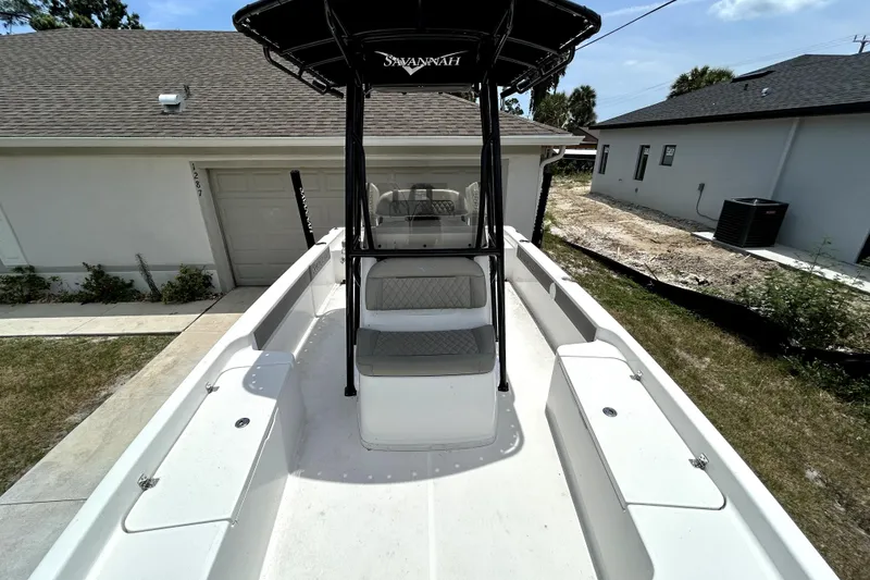 Slide: The Image of 2025 Savannah 210X boat with T-top, parked in residential driveway. - 38