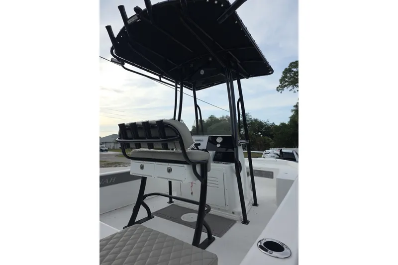 Slide: The Image of 2025 Savannah 210X boat interior with seating and console, featuring a sturdy T-top. - 4
