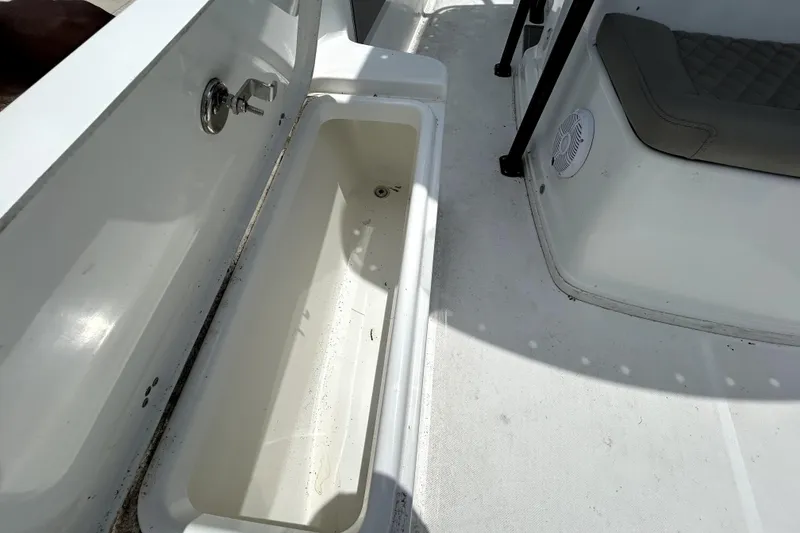 Slide: The Image of Interior view of 2025 Savannah 210X boat, featuring storage compartment and seating area. - 40