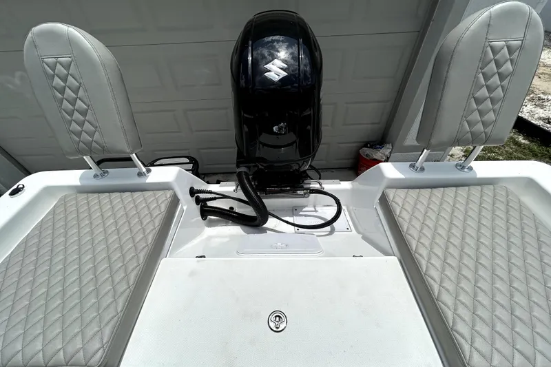 Slide: The Image of 2025 Savannah 210X boat interior with diamond-stitched seats and outboard motor. - 53