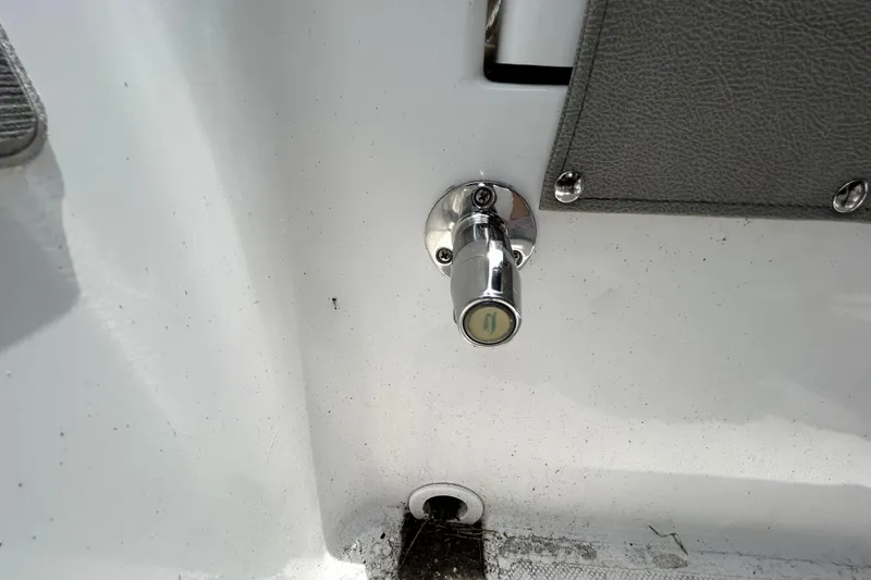 Slide: The Image of Chrome fitting on 2025 Savannah 210X boat interior, near gray panel. - 56