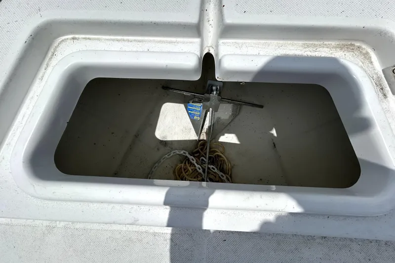 Slide: The Image of Anchor storage compartment on 2025 Savannah 210X boat, containing anchor and rope. - 57
