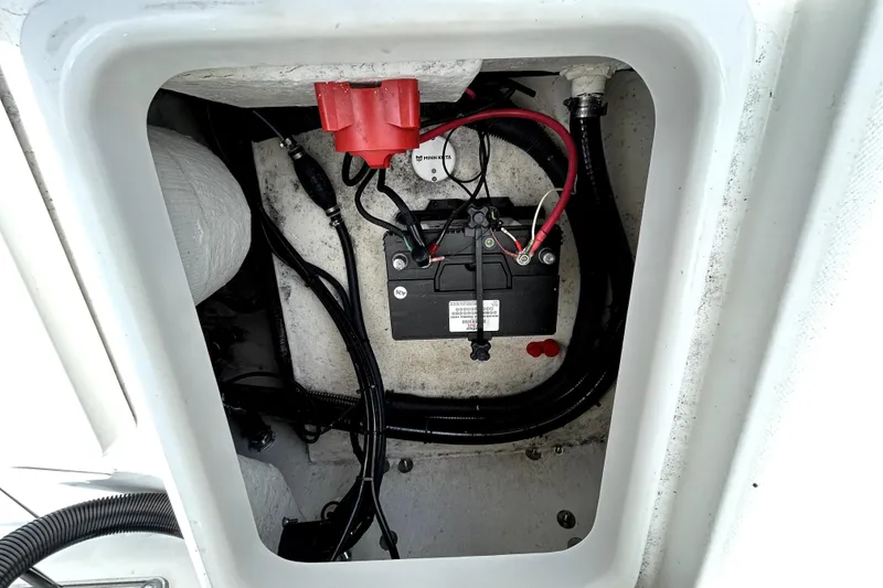 Slide: The Image of Battery compartment of 2025 Savannah 210X boat, featuring wiring and connections. - 58