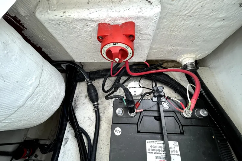 Slide: The Image of Battery compartment of 2025 Savannah 210X with wiring and switch. - 59