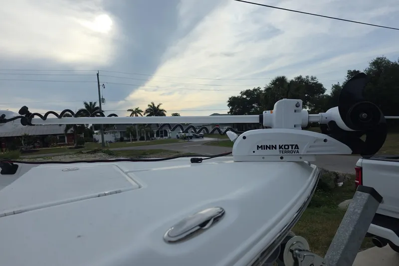 Slide: The Image of Minn Kota Terrova motor on 2025 Savannah 210X boat, parked outdoors under cloudy sky. - 6