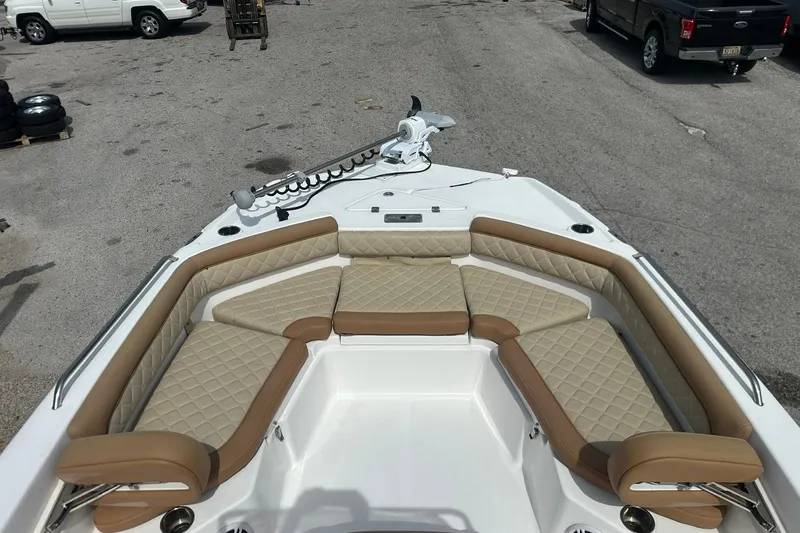 Slide: The Image of 2024 NauticStar 211 Hybrid boat with tan cushioned seating and modern design. - 12