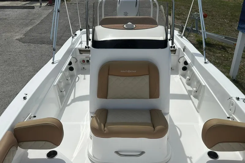 Slide: The Image of 2024 NauticStar 211 Hybrid boat interior with tan and white seating. - 14