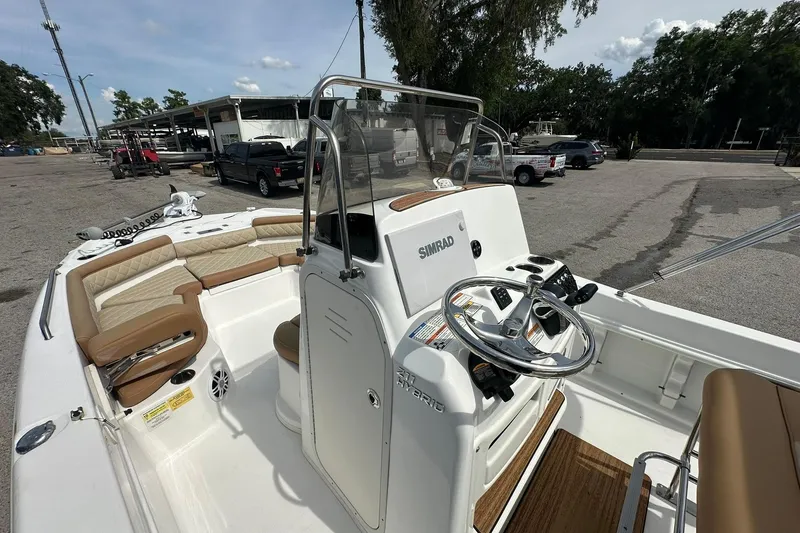 Slide: The Image of 2024 NauticStar 211 Hybrid boat interior with steering console and seating area. - 16