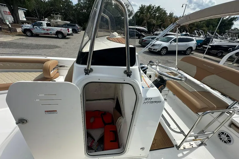 Slide: The Image of 2024 NauticStar 211 Hybrid boat interior with seating and storage compartment. - 18