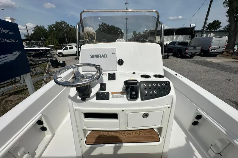 Slide: The Image of 2024 NauticStar 211 Hybrid boat console with steering wheel and controls. - 20
