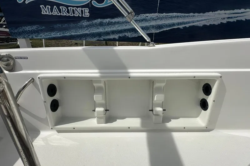 Slide: The Image of 2024 NauticStar 211 Hybrid boat interior with fresh water access and storage compartment. - 23