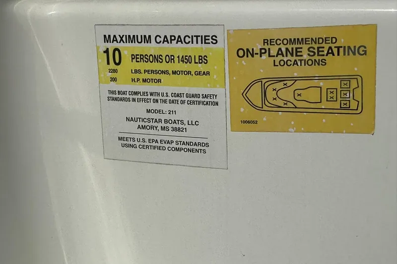 Slide: The Image of 2024 NauticStar 211 Hybrid capacity label, seating diagram, and safety compliance details. - 24